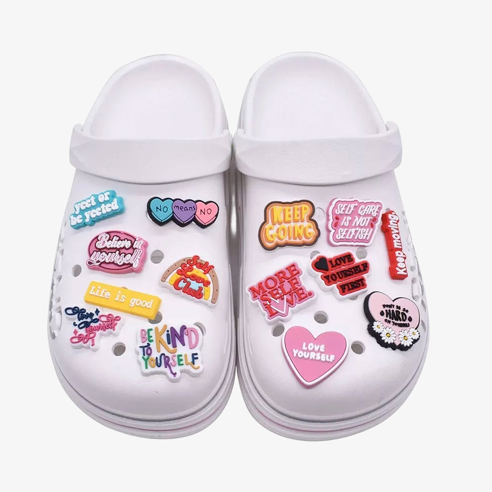 Custom PVC shoe charms fitted to white clogs